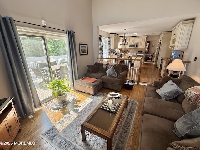 44 Diamond Ln, Howell, NJ 07731 - living area with wood finished floors, plenty of natural light, a high ceiling, and a chandelier