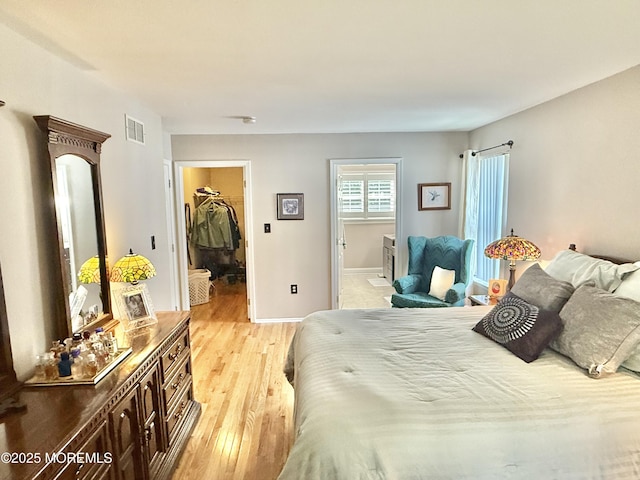 44 Diamond Ln, Howell, NJ 07731 - bedroom featuring a spacious closet, light wood-style floors, and ensuite bathroom