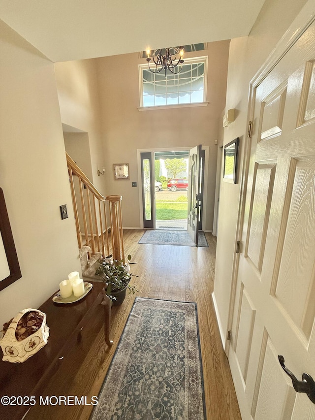 44 Diamond Ln, Howell, NJ 07731 - entrance foyer with wood finished floors, stairway, a high ceiling, and a chandelier