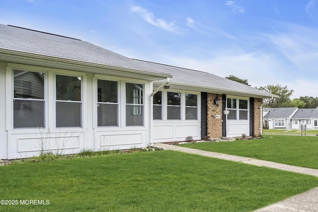 9 Edinburgh Ln Unit D, Manchester, NJ 08759 - view of front of house with a front lawn, brick siding, and roof with shingles