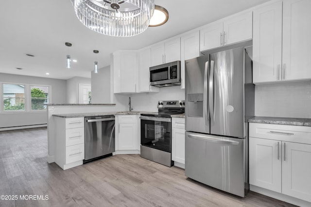 9 Edinburgh Ln Unit D, Manchester, NJ 08759 - kitchen with stainless steel appliances, a sink, white cabinets, light stone countertops, and tasteful backsplash