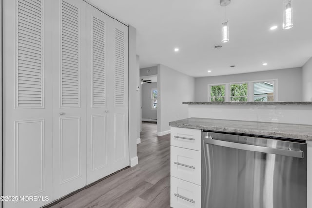 9 Edinburgh Ln Unit D, Manchester, NJ 08759 - kitchen with stainless steel dishwasher, light stone counters, white cabinetry, light wood-style flooring, and recessed lighting