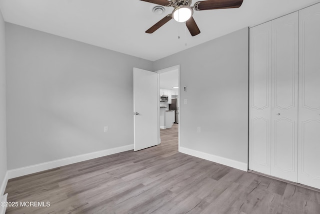 9 Edinburgh Ln Unit D, Manchester, NJ 08759 - unfurnished bedroom featuring wood finished floors, baseboards, a closet, a ceiling fan, and freestanding refrigerator