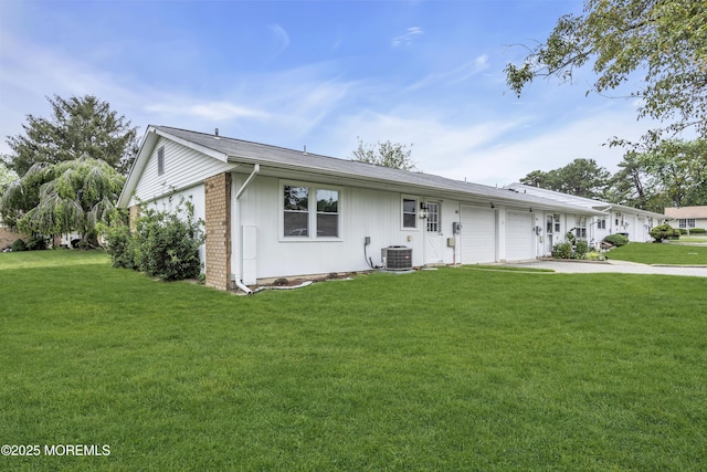 9 Edinburgh Ln Unit D, Manchester, NJ 08759 - single story home with an attached garage, central AC unit, a front lawn, and brick siding