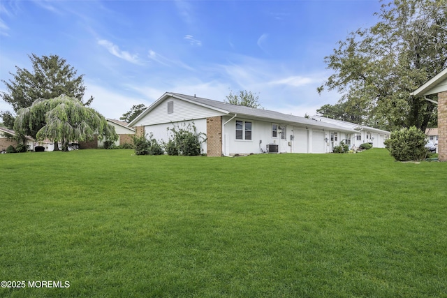 9 Edinburgh Ln Unit D, Manchester, NJ 08759 - rear view of house with a yard, brick siding, and cooling unit