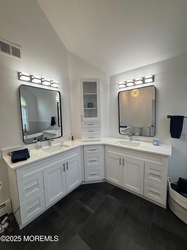 10 English Path, Freehold, NJ 07728 - bathroom featuring lofted ceiling, double vanity, and tile patterned floors