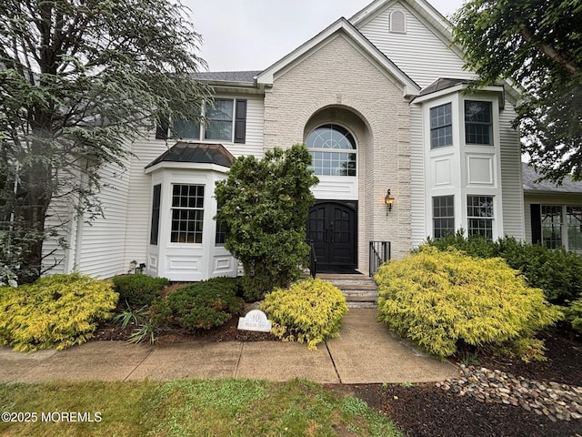 10 English Path, Freehold, NJ 07728 - traditional-style house with brick siding and a standing seam roof