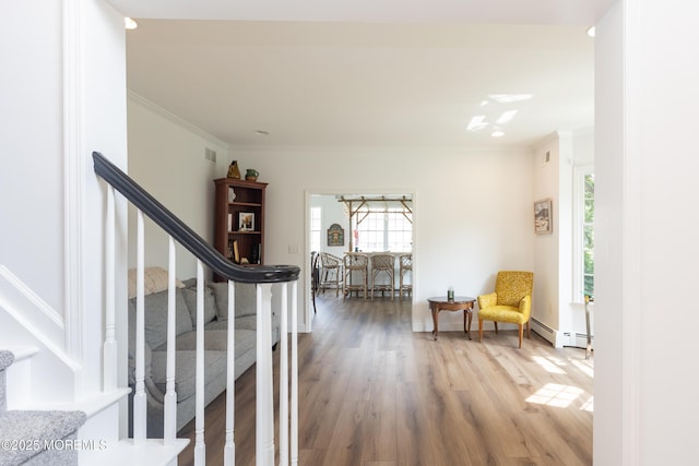 10 English Path, Freehold, NJ 07728 - hallway featuring crown molding, stairs, wood finished floors, and baseboard heating