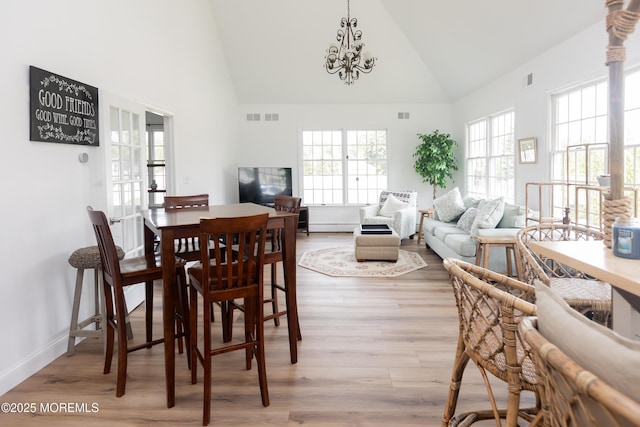 10 English Path, Freehold, NJ 07728 - dining area with high vaulted ceiling, light wood-style floors, and a chandelier
