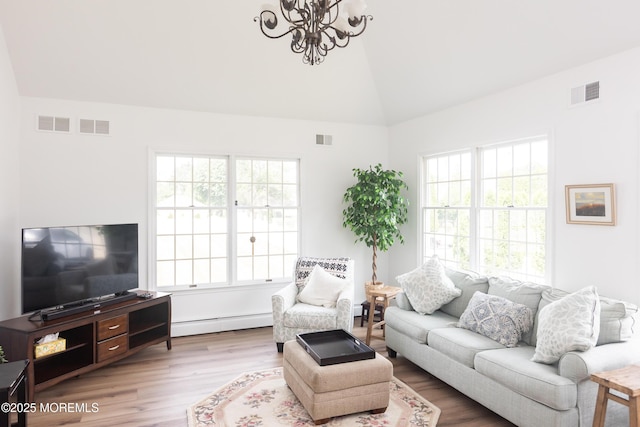 10 English Path, Freehold, NJ 07728 - living area featuring a baseboard heating unit, vaulted ceiling, a chandelier, and wood finished floors
