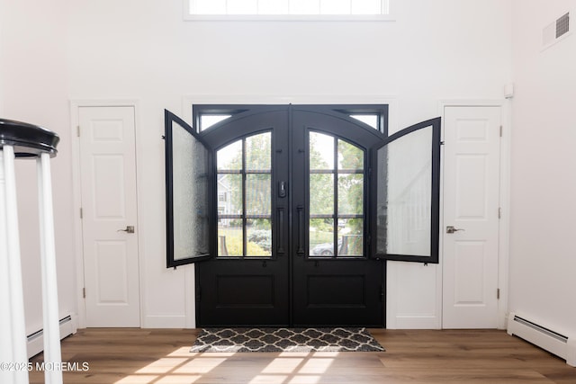 10 English Path, Freehold, NJ 07728 - entrance foyer with a baseboard radiator, wood finished floors, and french doors