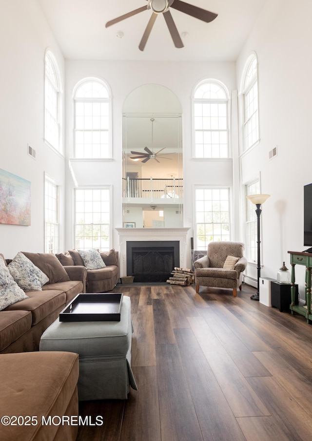 10 English Path, Freehold, NJ 07728 - living room featuring a ceiling fan, a towering ceiling, plenty of natural light, and a fireplace