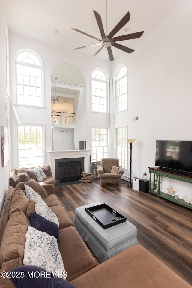 10 English Path, Freehold, NJ 07728 - living room with a high ceiling, a ceiling fan, wood finished floors, and a fireplace
