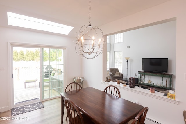 10 English Path, Freehold, NJ 07728 - dining room featuring a chandelier, light wood-style flooring, healthy amount of natural light, and a baseboard radiator