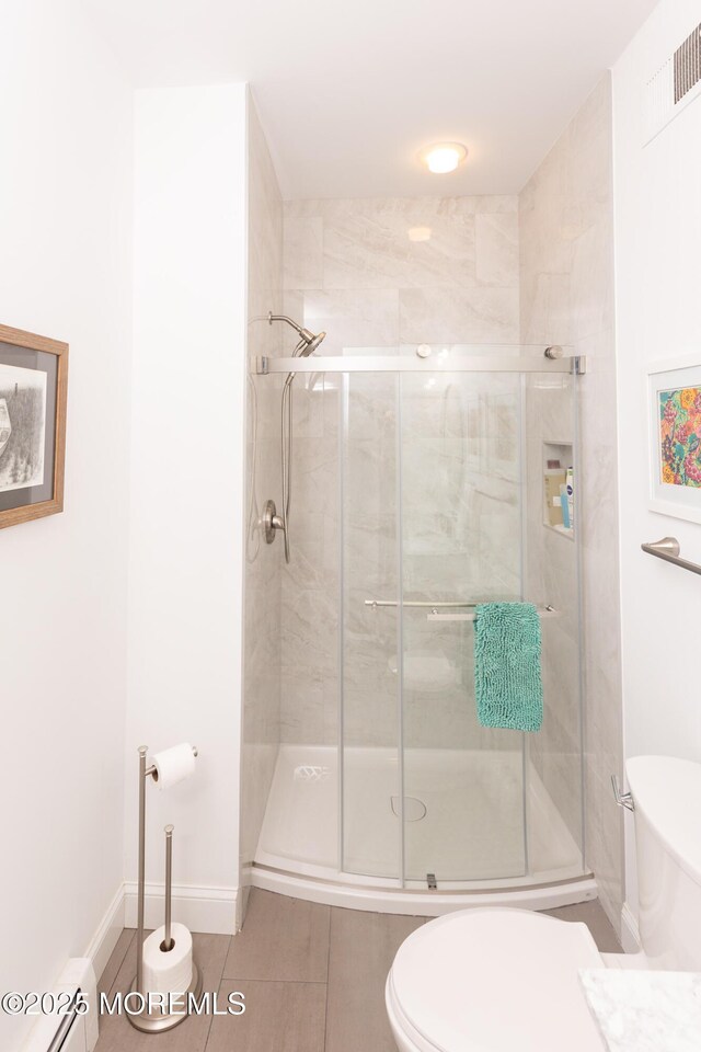 10 English Path, Freehold, NJ 07728 - full bath featuring a stall shower, baseboard heating, and tile patterned floors