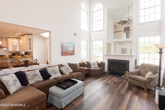 10 English Path, Freehold, NJ 07728 - living room with a high ceiling, dark wood finished floors, a chandelier, a fireplace with flush hearth, and a ceiling fan