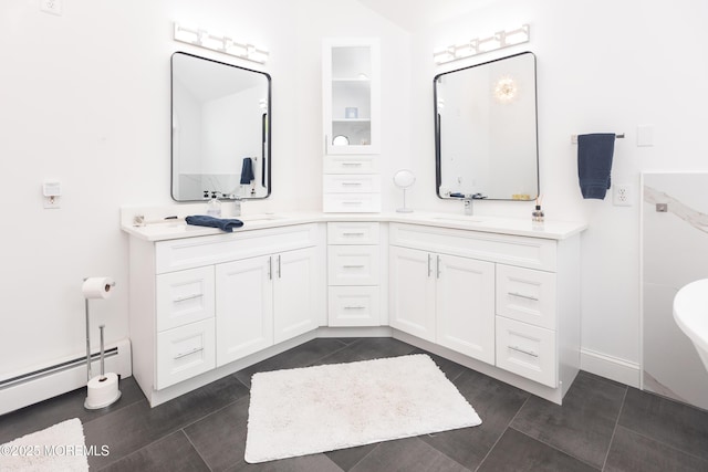 10 English Path, Freehold, NJ 07728 - bathroom featuring a baseboard radiator, double vanity, a freestanding tub, and tile patterned flooring