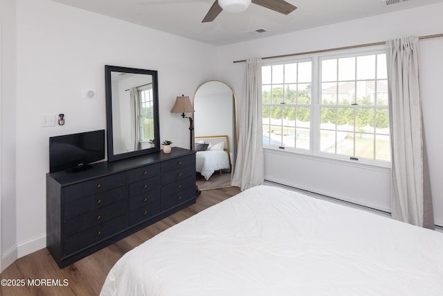 10 English Path, Freehold, NJ 07728 - bedroom with dark wood-style flooring, ceiling fan, and a baseboard radiator