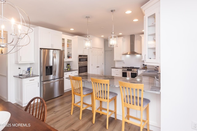 10 English Path, Freehold, NJ 07728 - kitchen featuring wall chimney exhaust hood, stainless steel appliances, a peninsula, wood finished floors, and recessed lighting