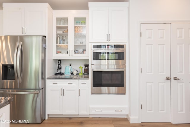 10 English Path, Freehold, NJ 07728 - kitchen with appliances with stainless steel finishes, white cabinets, glass insert cabinets, and light wood finished floors