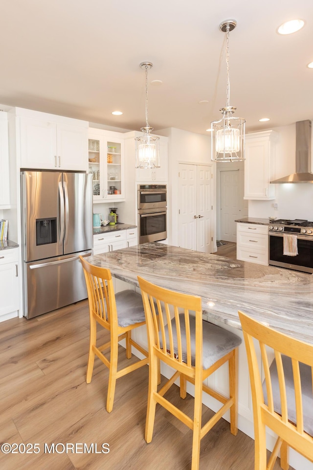 10 English Path, Freehold, NJ 07728 - kitchen featuring stainless steel appliances, wall chimney exhaust hood, a chandelier, white cabinetry, and recessed lighting