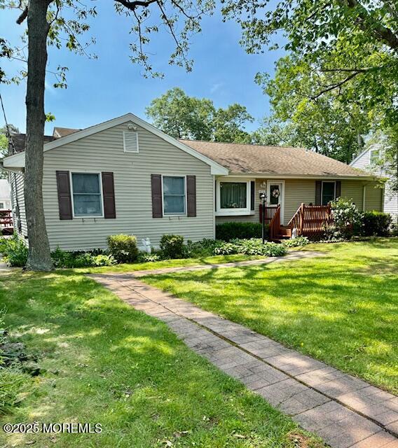 633 Thoroughfare Rd, Brick, NJ 08724 - ranch-style home featuring a front lawn and a wooden deck