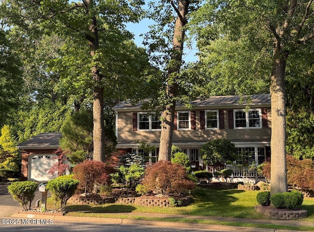 1 Algonquin Dr, Marlboro, NJ 07746 - view of front facade featuring a garage and a front lawn