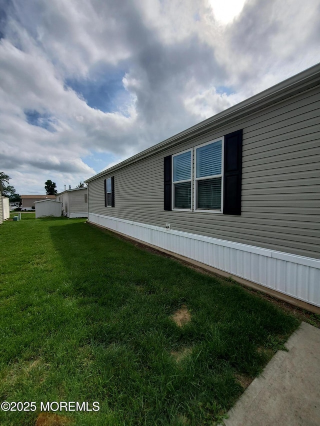 69 Robin Pl, Freehold, NJ 07728 - view of side of home with a lawn