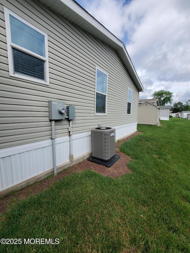 69 Robin Pl, Freehold, NJ 07728 - view of property exterior featuring a cooling unit and a yard