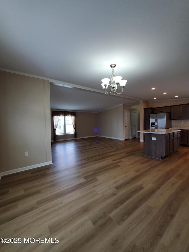 69 Robin Pl, Freehold, NJ 07728 - unfurnished living room featuring a chandelier, dark wood-style floors, ornamental molding, and recessed lighting