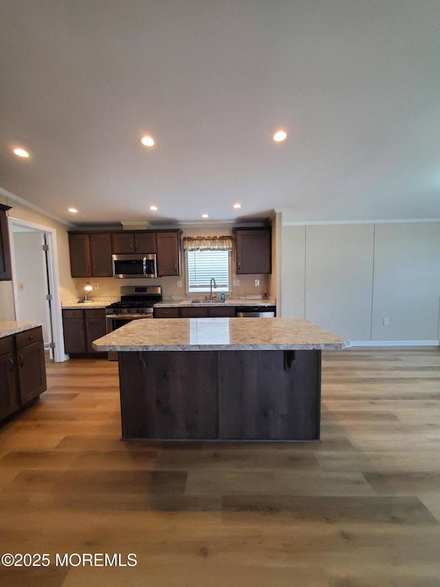 69 Robin Pl, Freehold, NJ 07728 - kitchen featuring appliances with stainless steel finishes, light wood-style floors, a center island, dark brown cabinets, and recessed lighting