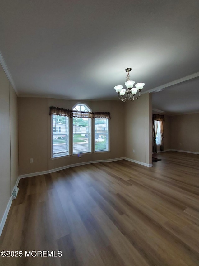 69 Robin Pl, Freehold, NJ 07728 - spare room with a chandelier, wood finished floors, and crown molding