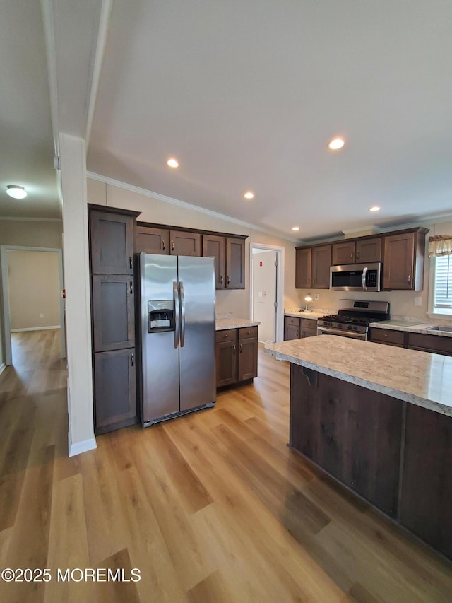 69 Robin Pl, Freehold, NJ 07728 - kitchen with stainless steel appliances, crown molding, light wood finished floors, dark brown cabinets, and recessed lighting