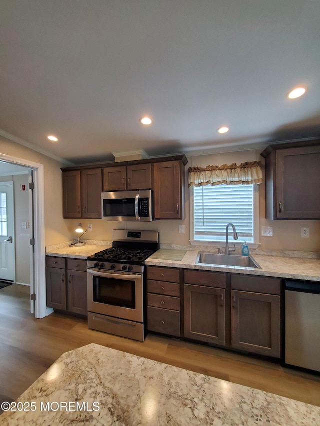 69 Robin Pl, Freehold, NJ 07728 - kitchen featuring appliances with stainless steel finishes, light wood-style floors, plenty of natural light, recessed lighting, and light countertops