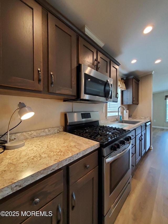 69 Robin Pl, Freehold, NJ 07728 - kitchen featuring appliances with stainless steel finishes, light wood-type flooring, dark brown cabinetry, light countertops, and recessed lighting