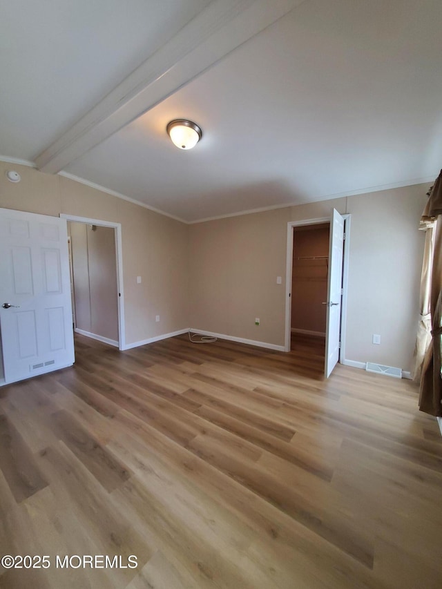 69 Robin Pl, Freehold, NJ 07728 - empty room with light wood-style floors, ornamental molding, and beam ceiling