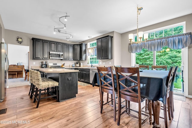 46 Timberline Rd, Bayville, NJ 08721 - kitchen featuring stainless steel appliances, a center island, light countertops, a chandelier, and a breakfast bar