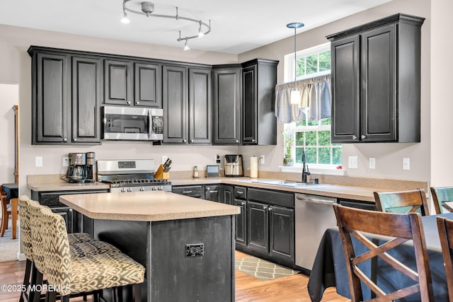 46 Timberline Rd, Bayville, NJ 08721 - kitchen with appliances with stainless steel finishes, dark cabinets, light wood-style flooring, and light countertops