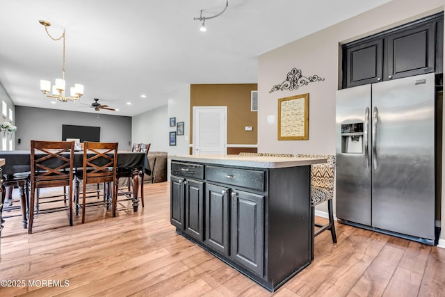 46 Timberline Rd, Bayville, NJ 08721 - kitchen with stainless steel refrigerator with ice dispenser, light wood-style flooring, a chandelier, dark cabinets, and recessed lighting