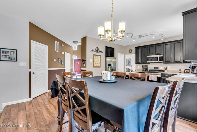 46 Timberline Rd, Bayville, NJ 08721 - dining area featuring a chandelier and light wood-type flooring