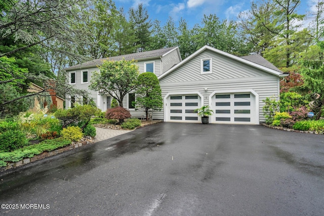 5 Leighton Dr, East Brunswick, NJ 08816 - view of front of home featuring driveway, an attached garage, and roof with shingles
