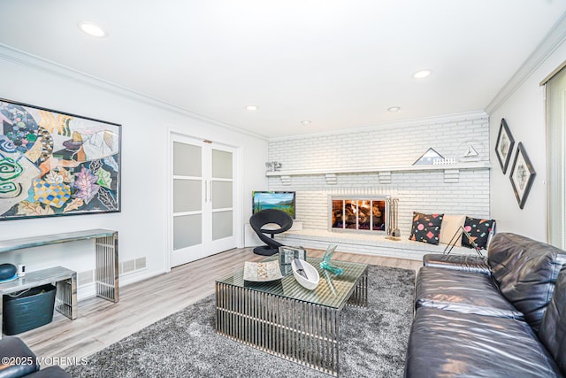5 Leighton Dr, East Brunswick, NJ 08816 - living area with crown molding, wood finished floors, a fireplace, brick wall, and recessed lighting