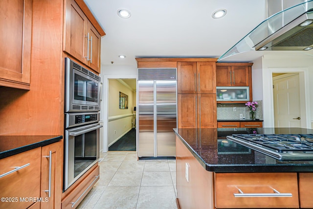 5 Leighton Dr, East Brunswick, NJ 08816 - kitchen with built in appliances, brown cabinets, tasteful backsplash, dark stone countertops, and light tile patterned flooring