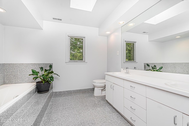 5 Leighton Dr, East Brunswick, NJ 08816 - full bathroom with a skylight, double vanity, a bath, speckle patterned floor, and recessed lighting