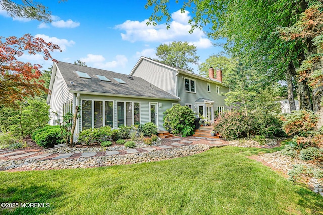 5 Leighton Dr, East Brunswick, NJ 08816 - back of property featuring a chimney, a lawn, and a shingled roof