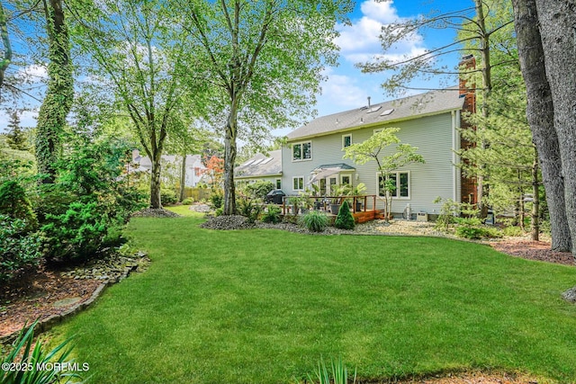 5 Leighton Dr, East Brunswick, NJ 08816 - back of property featuring a chimney, a lawn, and a wooden deck