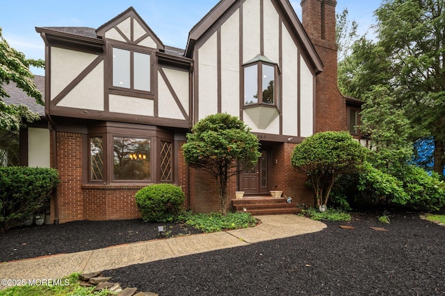 245 Borden Rd, Middletown, NJ 07748 - tudor home featuring stucco siding, a chimney, and brick siding