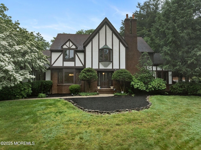 245 Borden Rd, Middletown, NJ 07748 - tudor home with a front lawn, stucco siding, a chimney, and brick siding
