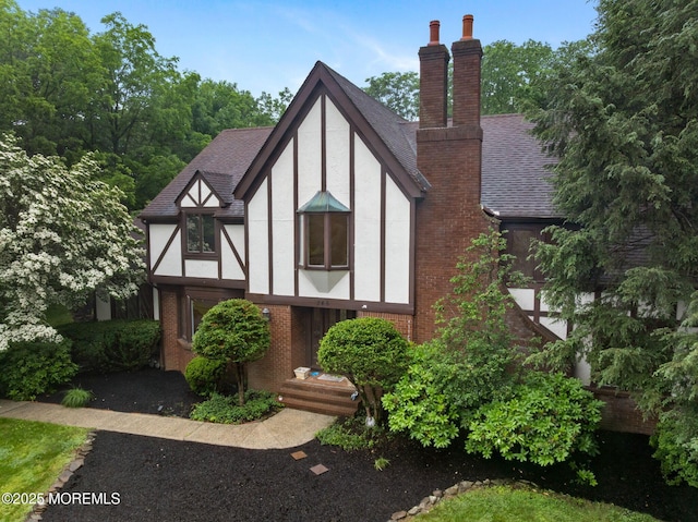 245 Borden Rd, Middletown, NJ 07748 - english style home featuring a chimney, stucco siding, brick siding, and a shingled roof