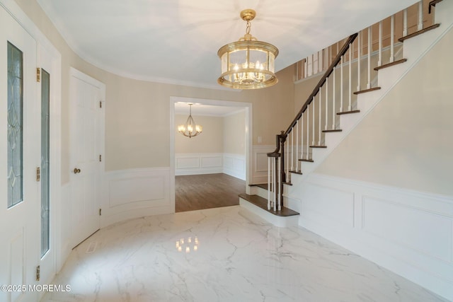 245 Borden Rd, Middletown, NJ 07748 - foyer featuring a chandelier, a decorative wall, stairs, a wainscoted wall, and marble finish floors